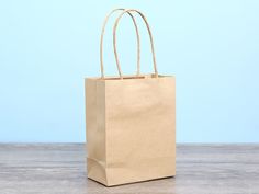 a brown paper bag sitting on top of a wooden table