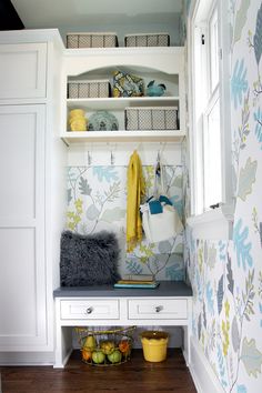 a white closet with blue and yellow wallpaper