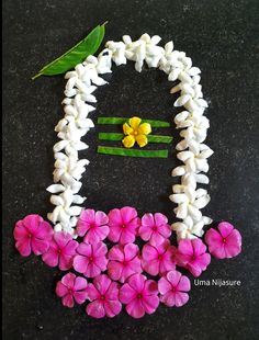 flowers are arranged in the shape of a woman's face on a black surface