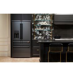 a black refrigerator freezer sitting inside of a kitchen