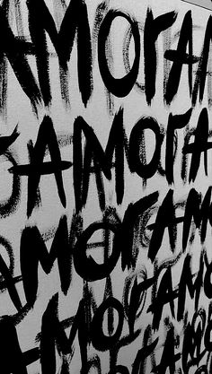 black and white photograph of graffiti on the wall