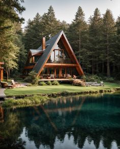 a large house sitting on top of a lush green hillside next to a lake and forest