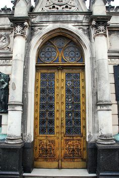 an old building with ornate doors and statues