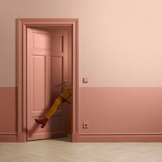 an open pink door with a yellow scarf hanging from it's handle in a room