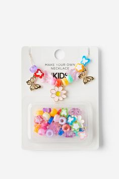 a package of colorful beads and charms on a white background with the words make your own kid