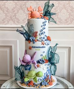 a three tiered cake decorated with sea creatures