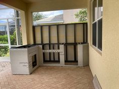 an empty room with some boxes on the floor in front of it and windows above