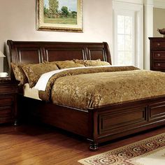 a large bed sitting on top of a wooden floor next to a dresser and mirror