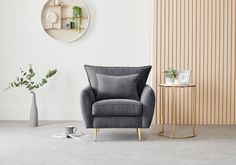 modern charcoal grey velvet armchair with winged back cushion corners on gold tapered metal legs