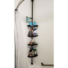 a bathroom with a shower, toilet and shelves on the side of the bathtub