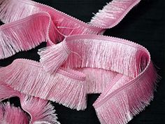 pink ribbon with fringes on black background