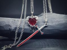 Silver-Plated Gothic Heart and Sword Necklace Set - A Meaningful Gift for Couples, Lovers, and Best Friends This high-quality silver-plated and enamel gothic necklace set features two elegant pieces: a heart and a sword, symbolizing love and loyalty. It's the perfect gift for lovers, couples, or best friends who want to celebrate their bond with a stylish and meaningful accessory. Ideal for those who love gothic style, these necklaces offer a bold and unique statement. The set comes in a beautif Gothic Heart Shaped Necklace As Gift, Gothic Heart-shaped Anniversary Jewelry, Gothic Heart-shaped Jewelry With Adjustable Chain, Gothic Heart-shaped Necklace For Valentine's Day, Red Gothic Necklace With Heart Charm, Gothic Necklace, Unusual Jewelry, Romantic Gift, Pendant Design