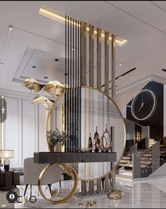 a living room filled with furniture and a clock on top of a table in front of a staircase