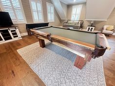 a pool table sitting in the middle of a living room