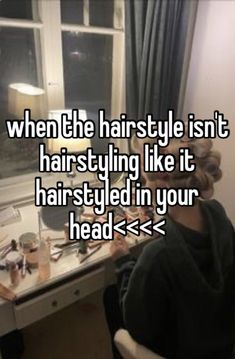 a woman sitting in front of a mirror with her hair dryer on the table