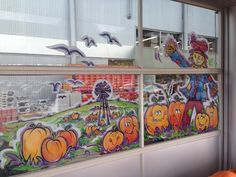 there are many pumpkins painted on the windows