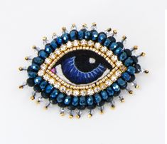 a brooch with an evil eye on it