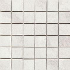 a white tile wall that is very close up to it's surface and has many squares