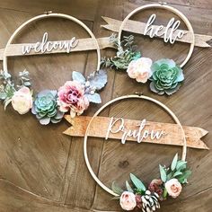 three hoop wreaths with flowers and welcome signs