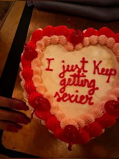 a heart shaped cake with the words i just keep getting served written on it