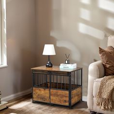 a living room with a couch, table and lamp on it's end table