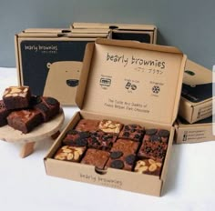 two boxes of brownies and one box of chocolate with walnuts on the side