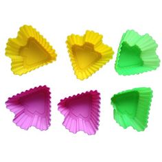 four heart shaped cupcake pans are shown in different colors and shapes, one is yellow, the other is pink