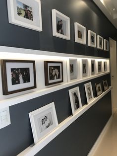 the wall is lined with many framed photographs