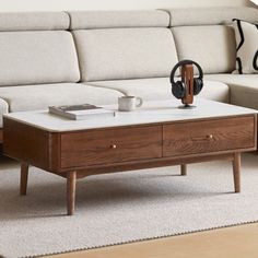 a coffee table with headphones on it in front of a couch