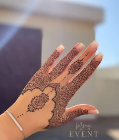 a woman's hand with henna on it