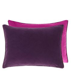 two purple and pink pillows on a white background