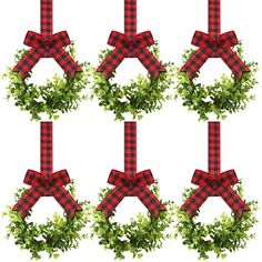 a set of four christmas wreaths with red and black plaid bows