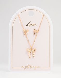 Charm with this gold bow necklace and earring set. Perfect as a thoughtful gift, the delicate bows and gleaming gold for adding understated luxury to any outfit. Shine brightly, whether you're dressing up or down. Dimensions: Chain Length: 45 cm Earring Length 9 mm x Earring Width 9 mm Extender: 8 cm Feature Dimensions: Pendant Width 15 mm x Pendant Height 15 mm | Lovisa Gold Bows Necklace & Earring Set Cheap Gold Charm Necklaces For Bridesmaids, Gold Necklaces With Bow For Gifts, Gold Plated Bow Jewelry Gift, Elegant Gold Necklace With Bow Detail, Bow Necklace Gold, Lovisa Jewellery Necklaces, Bow Necklace, Understated Luxury, Necklace And Earring Set