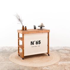 a table with a sign that says n'65 on it and two cups sitting on top