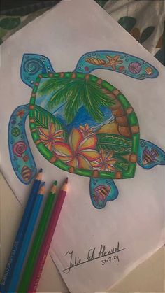 a drawing of a turtle with flowers and palm trees on it's back, next to two colored pencils