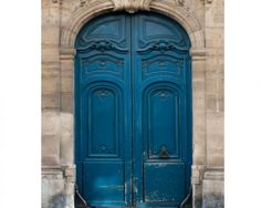 an old building with two large blue doors