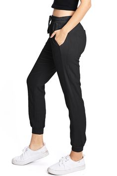 Light weight linen jogger pants with a high rise fit, a stretchy smocked waist and a drawstring tie. Pockets on the front and back. CARE | Machine Wash Cold CONTENTS | 55% Linen 45% Viscose MEASUREMENTS | 35"/89 cm Top to Bottom 25"/64 cm Inseam 10"/25 cm Rise (Size Small) MODEL | 5'8 - wearing a size Small IMPORTED Comfortable Elevated Casual Bottoms, Sporty Mid-rise Bottoms For Loungewear, Loosely Fitted Pull-on Style Sweatpants, Mid-rise Joggers For Loungewear, Cotton Bottoms With Gathered Waist, Versatile Tapered Leg Sweatpants, Versatile Tapered Leg Pull-on Sweatpants, Versatile Ankle-length Pull-on Sweatpants, Casual Cotton Pants With Gathered Waist