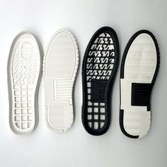 three different types of shoes are lined up on a white surface, one is black and the other is white