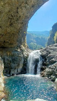 there is a large waterfall in the middle of this river and it's blue water