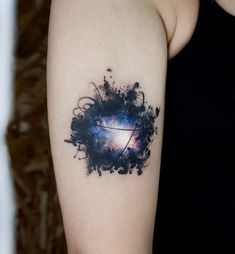 a woman's arm with a space themed tattoo on it