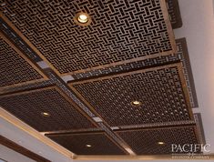 the ceiling is made up of metal squares and square shapes with lights on each side