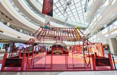 the inside of a shopping mall filled with lots of red and yellow items on display