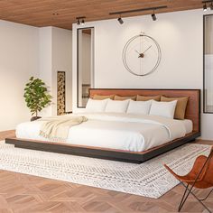 a large bed sitting on top of a wooden floor next to a chair and window