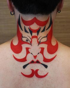 the back of a man's neck with red and black designs on it