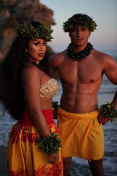 a man and woman standing next to each other on the beach