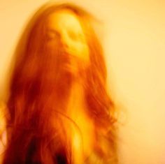 a blurry photo of a woman with long hair