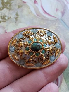 This is a vintage Micheal Golan, oval, gold tone metal, geometric pin or brooch or it can be worn as a pendant, in shades of blue. This measures just shy of 1.75 x just over 1.25 inches. Don't forget to stop in at my other Etsy shop... http://www.etsy.com/shop/xtdesigns. Follow me on Twitter at... MyYiayiaHadThat@MyYiayiaHadThat. If you have a wish list or are looking for something specific, please ask. I may have exactly what you are looking for. As always please convo me with any questions or Blue Oval Brooch, Antique Gold Oval Brooch, Antique Gold Oval Brooches, Antique Gold Brooch With Oval Cabochon, Antique Gold Oval Cabochon Brooch, Antique Gold Brooches With Oval Cabochon, Antique Gold Oval Cabochon Brooches, Handmade Brass Gold Brooches, Ornate Gold Cabochon Brooches