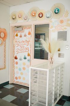 the front door to a candy shop is decorated in pastel colors and paper decorations