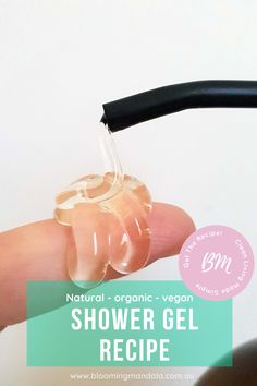 a hand holding an object with the words, shower gel recipe on it's side