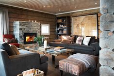 a living room filled with furniture and a fire place in the middle of it's walls